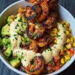 Grilled shrimp bowl with corn, guacamole, and chipotle sauce