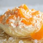 Mandarin Orange Jello Salad in a glass bowl with creamy whipped texture and citrus segments