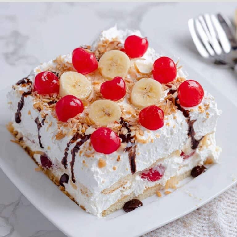 No Bake Banana Split Cake layered with whipped cream and fruit