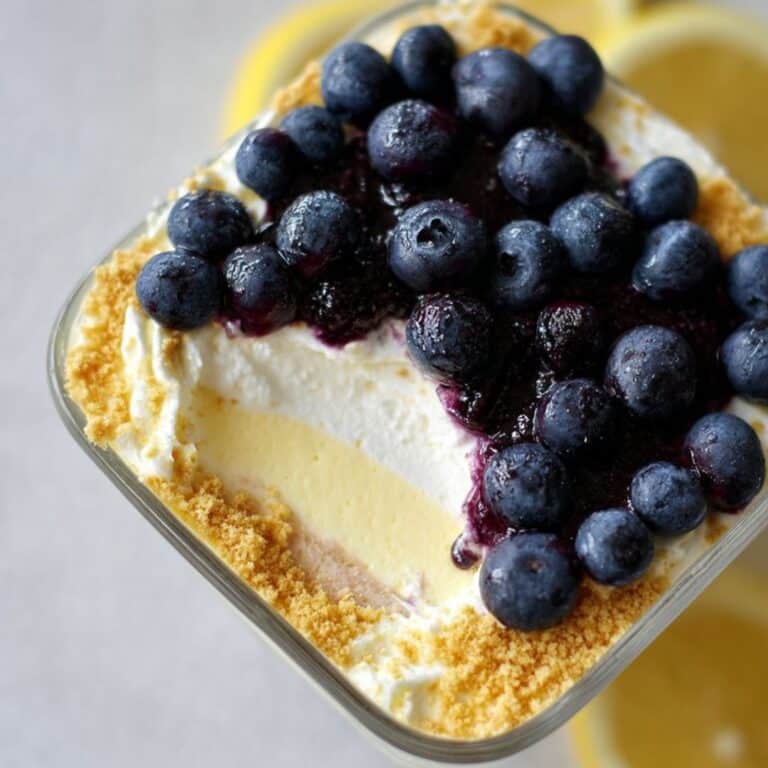 No bake lemon blueberry dessert in glass jars with layers of yogurt and blueberry compote