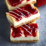Two layered Philadelphia Cheesecake Bars on a serving plate