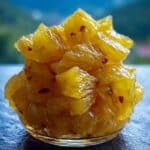 Pineapple Cowboy Candy in a glass bowl close-up with sweet and spicy glaze