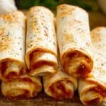 Pizza Roll Ups stacked with melted cheese and herbs