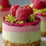 Raspberry Pistachio Mousse Cakes with fresh raspberries and chopped pistachios on top