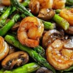 Shrimp and Asparagus Stir-Fry with Mushrooms in a white bowl
