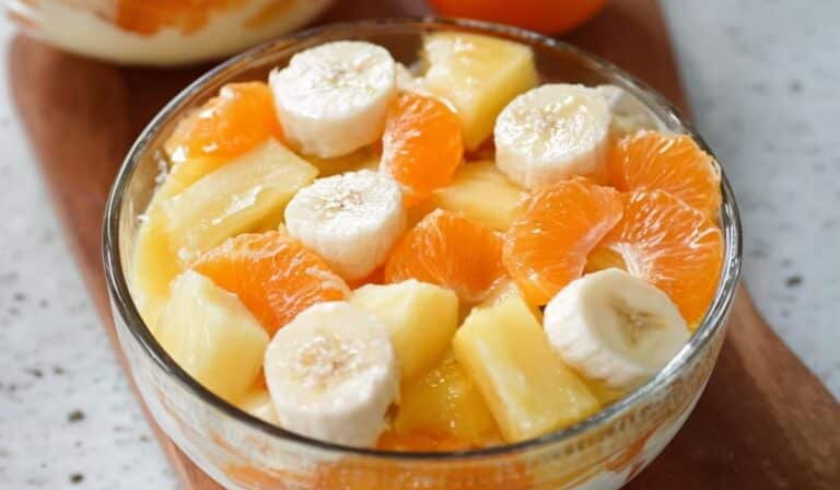 Sunshine Salad with bananas, pineapple, and orange segments in a glass bowl