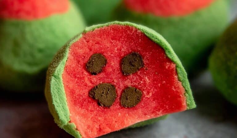 Watermelon truffles with green coating and chocolate seeds inside