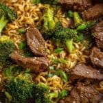 Beef and Broccoli Ramen in a stainless steel pan with rich soy-based broth