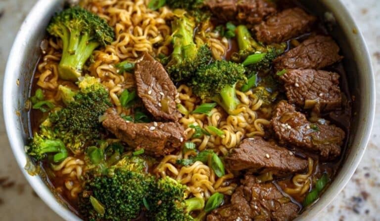 Beef and Broccoli Ramen in a stainless steel pan with rich soy-based broth