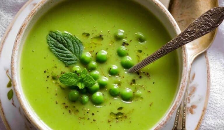 Green Pea Soup in white bowl with mint garnish