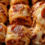 High Protein and Low Calorie Pepperoni Pizza Rolls baked to golden perfection on a wooden board