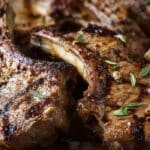Simple Grilled Lamb Chops served on a plate with herbs