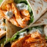 Buffalo Chicken Wraps filled with spicy shredded chicken, lettuce, and creamy dressing
