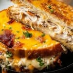 Cheddar and Bacon Turkey Melt on Sourdough sliced open with melted cheddar and crispy bacon