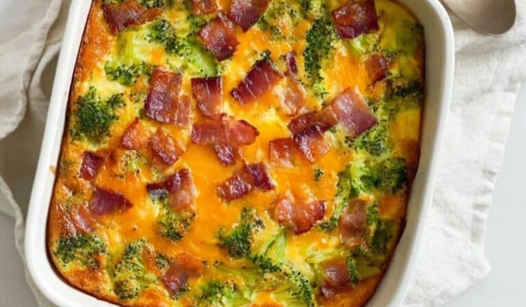 Broccoli Cheddar Egg Bake with Turkey Bacon in a white casserole dish, freshly baked