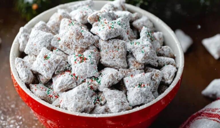 Christmas Puppy Chow in red bowl with festive background