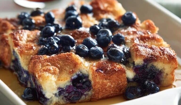 Close-up of Overnight Blueberry French Toast Casserole with syrup and blueberries