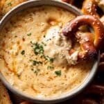 Beer Cheese Dip served with pretzels on rustic table
