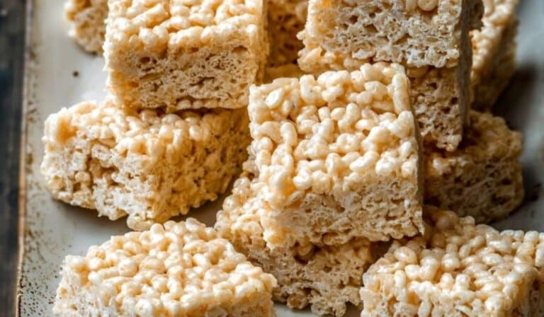 Family-Favorite Rice Krispie Treats stacked on wooden plate