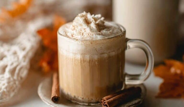 Pouring homemade pumpkin coffee creamer into a white mug