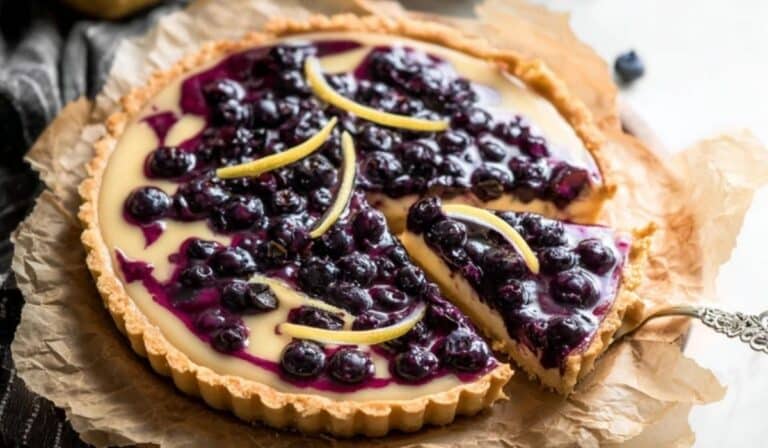 Top-down view of a lemon blueberry tart elegantly sliced