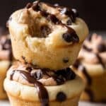 Molten Cookie Dough Cupcakes with gooey centers stacked on rustic table