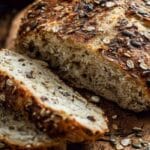No Knead Seeded Oat Bread sliced and served rustic style