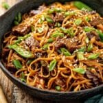 Hoisin Beef Noodles served in a ceramic bowl with sesame seeds