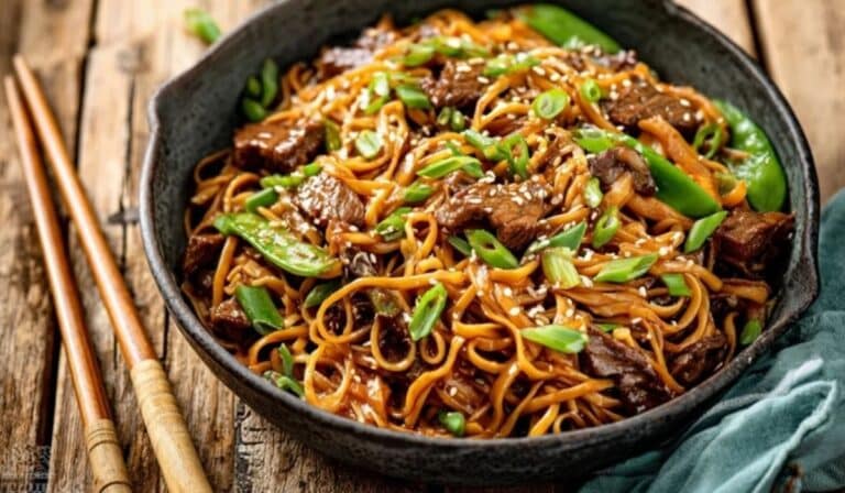 Hoisin Beef Noodles served in a ceramic bowl with sesame seeds