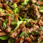 Quick and Healthy Moo Shu Pork served in lettuce cups on a wooden plate