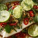 Thai Lime Garlic Steamed Fish on white ceramic plate