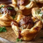 BBQ Meatball Crescent Cups served on a wooden board