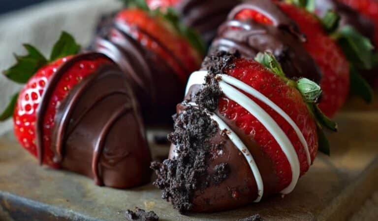 Oreo Truffle-Stuffed Strawberries arranged on a dark serving board