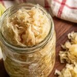 5-day homemade sauerkraut in a glass jar on a wooden board