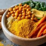 Anti-inflammatory golden turmeric bowl with quinoa, roasted veggies, chickpeas and avocado