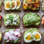Avocado toast 10 ways on a brunch board with colorful toppings