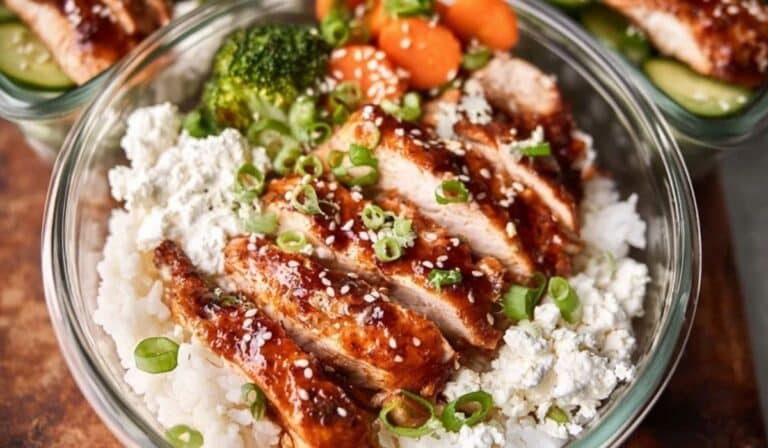 Chicken and rice meal prep bowls with roasted vegetables and lemon yogurt sauce