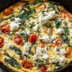 Egg white frittata with feta in a cast iron skillet on a rustic table