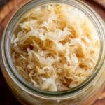 Homemade sauerkraut 7-day in a glass jar with crisp fermented cabbage