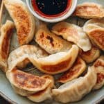 Pan-fried cabbage dumplings with golden crispy bottoms in a skillet for Dinner