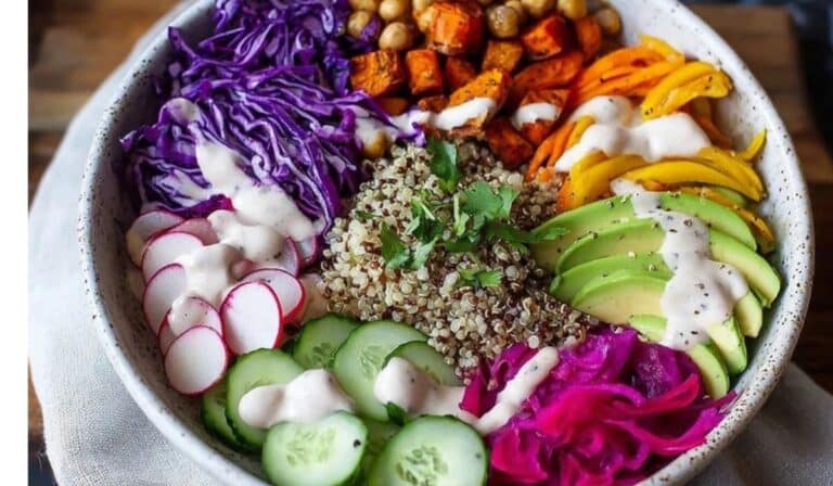 Rainbow grain bowl with tahini topped with colorful veggies and chickpeas