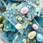 Robin Egg Chocolate Bark broken into pastel shards on parchment