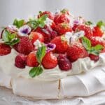 Strawberry pavlova spring cake layered with whipped cream and fresh strawberries